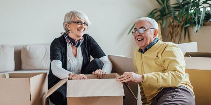A senior couple packing their possessions.